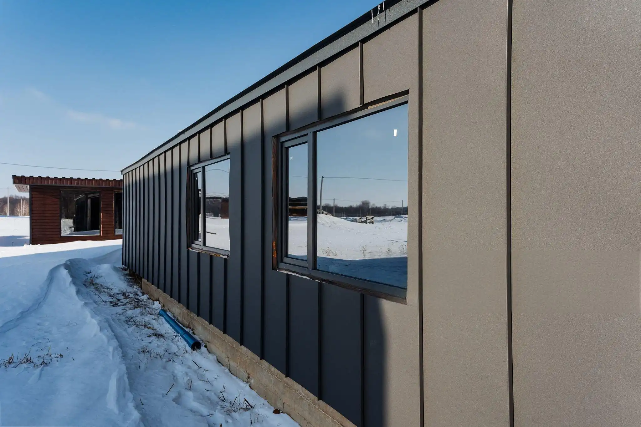 Vertical standing seam metal cladding