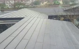 What is the difference between a flat seam and a standing seam metal roof?